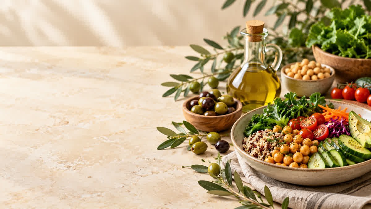 Extra virgin olive oil with fresh olives and vegetables on a table