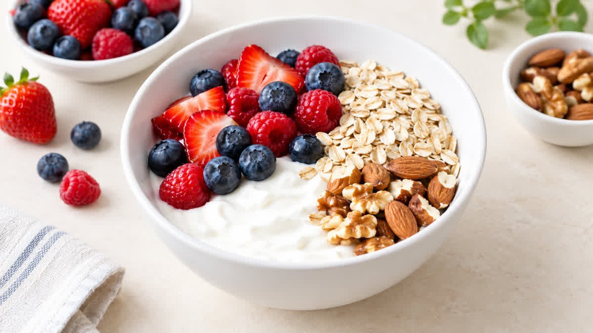 Plain Greek yogurt with fresh berries, oats, and nuts
