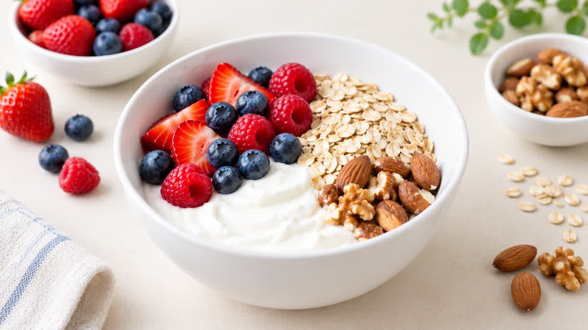 Plain Greek yogurt served with fresh berries, oats, and nuts