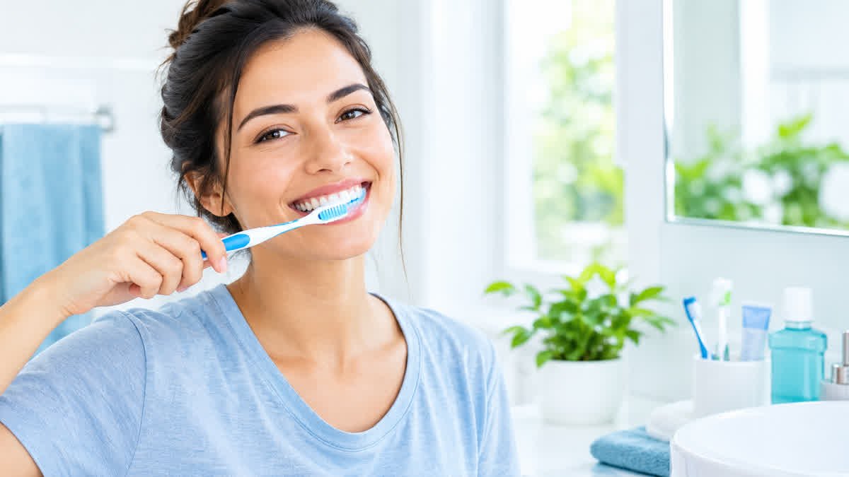 Adult brushing teeth as part of a daily routine to help prevent bad breath.