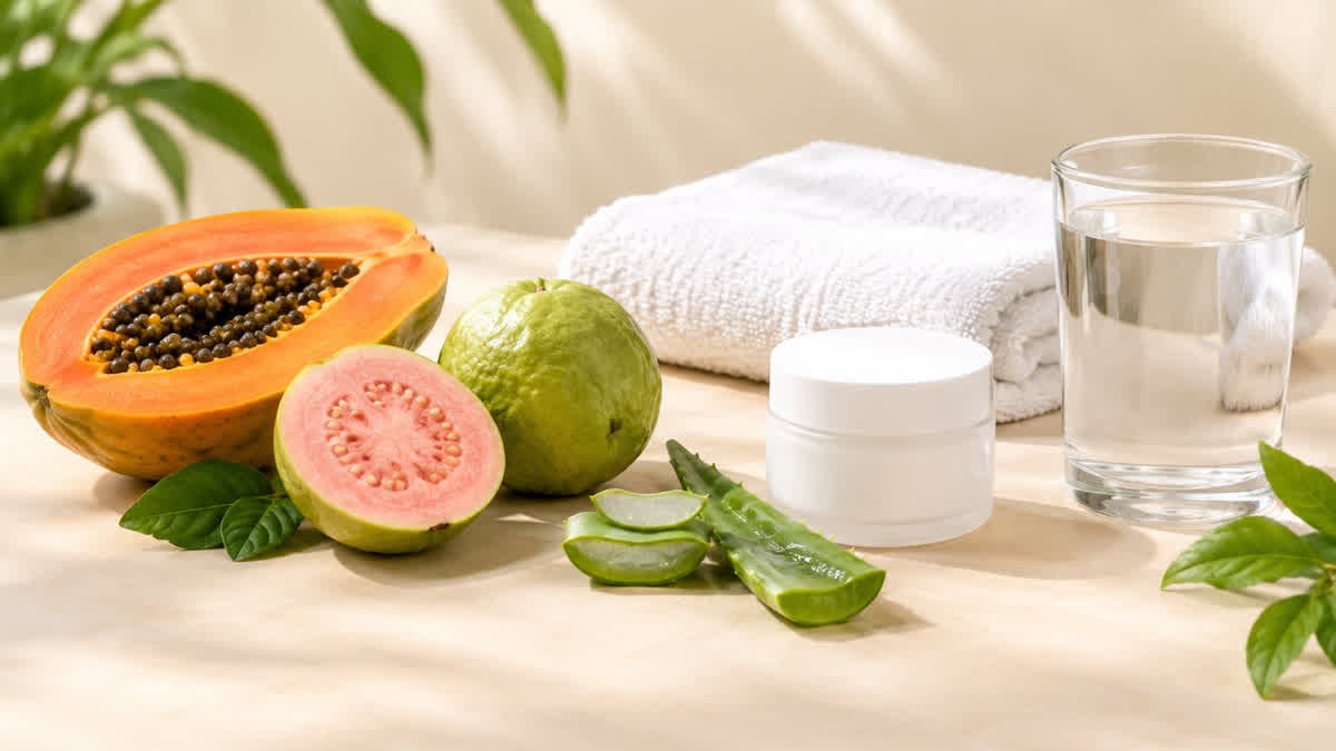 Fresh fruit, aloe vera, moisturizer, and water arranged to represent natural skincare habits for healthy-looking, glowing skin.