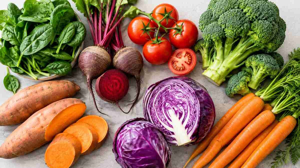 Fresh leafy greens, beetroot, tomatoes, broccoli, and other vegetables associated with a heart-healthy diet.